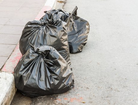 Workers sorting wood and metal waste on-site